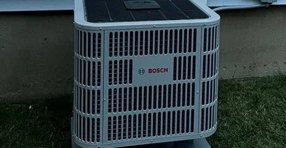 Professional condenser coil cleaning during maintenance visit