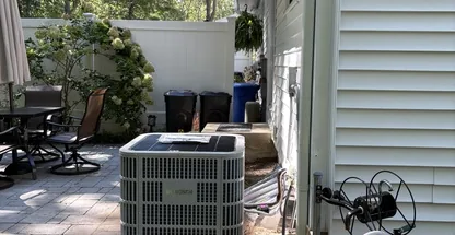 NATE Certified tech inspecting outdoor AC unit