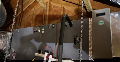 Technician inspecting furnace heat exchanger for cracks