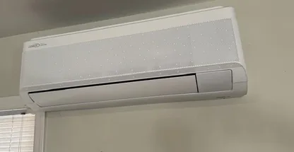 Compact ceiling cassette mini-split in renovated room