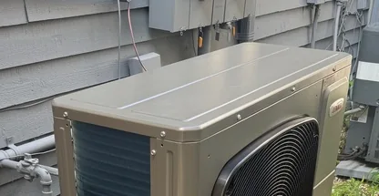 Outdoor ductless mini-split condenser inspected during annual tune-up