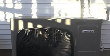 Ductless mini-split outdoor condenser mounted on wall bracket